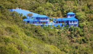 a scenic view of the mare blu villa nestled in the lush hills of st. john, usvi.