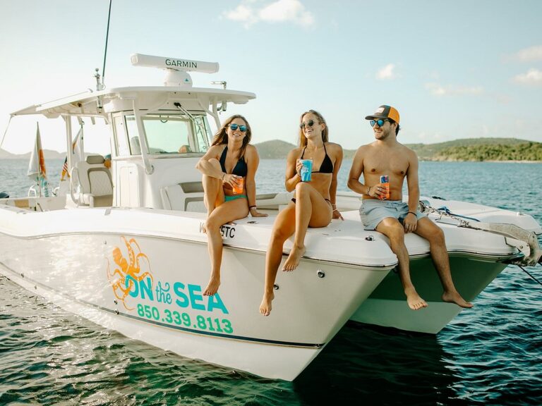 three happy vacationers enjoying on the sea charter boats in the virgin islands.