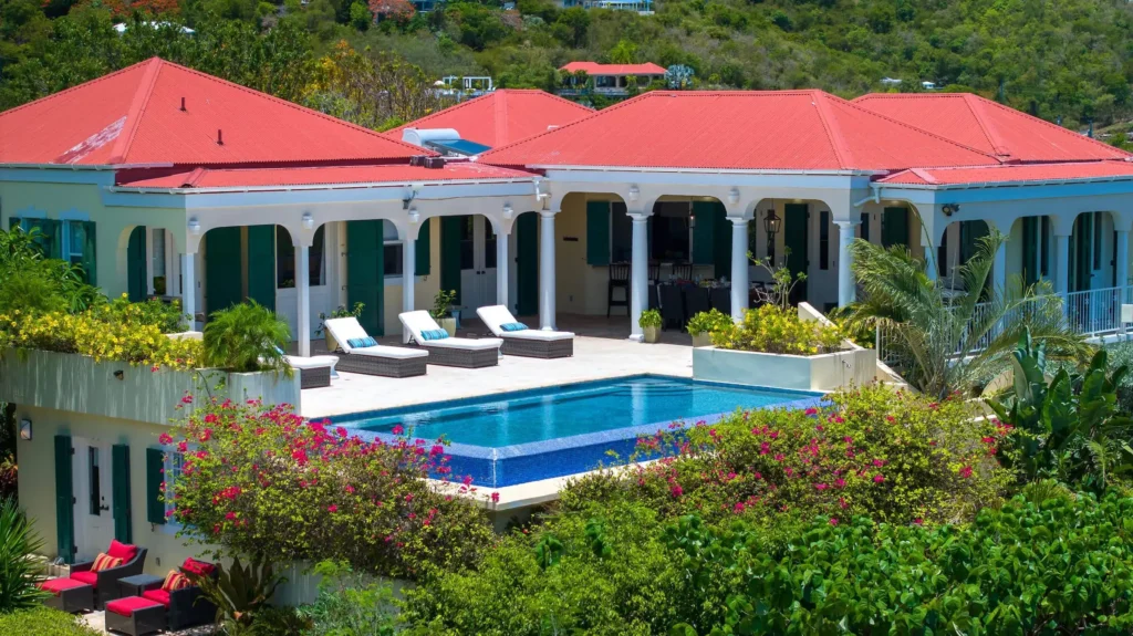 The exterior of Tre Visa Estate showing the expansive patio and luxurious private pool