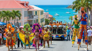 people in brightly colored outfits as a part of the St. Thomas Carnival parade.